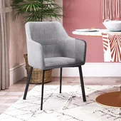 gray fabric dining armchair against pink wall